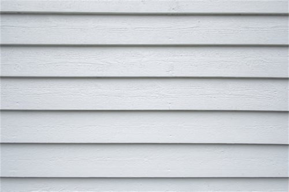 Clean white horizontal lap siding on the exterior wall of a Denver-area home