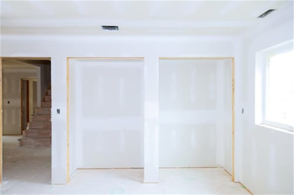 Freshly hung and taped drywall in a residential interior ready for texture and paint in Denver, CO
