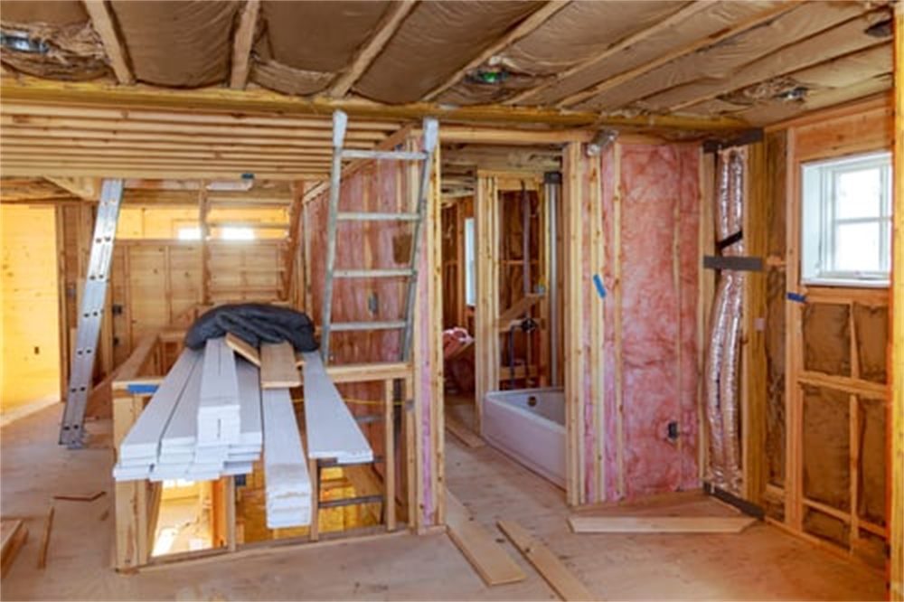 Home interior under construction with framing, insulation and materials staged for a Denver, Colorado remodel