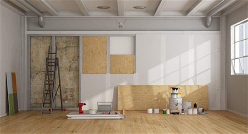Interior renovation in progress with new drywall and finished hardwood flooring in a Denver, Colorado home